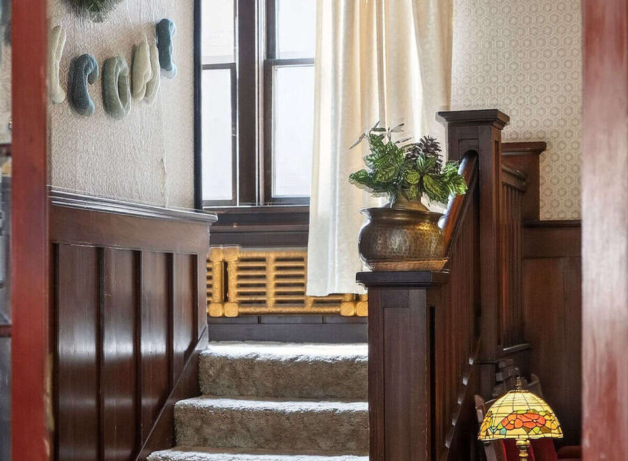 Step into timeless elegance with this stunning property featuring a beautifully crafted staircase.