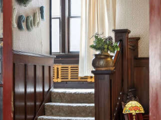 Step into timeless elegance with this stunning property featuring a beautifully crafted staircase.