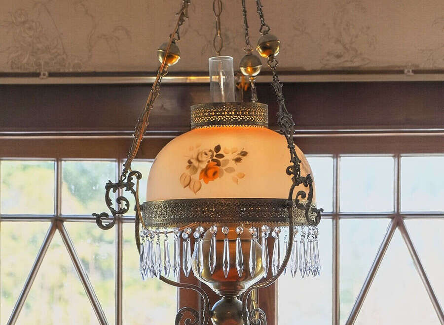 This stunning property features a beautiful antique chandelier, adding a touch of elegance and charm to the space.