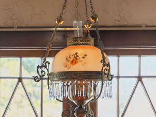 This stunning property features a beautiful antique chandelier, adding a touch of elegance and charm to the space.