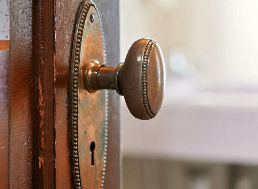 A close-up shot showcases a vintage door with a classic brass doorknob, adding a touch of elegance to any home.