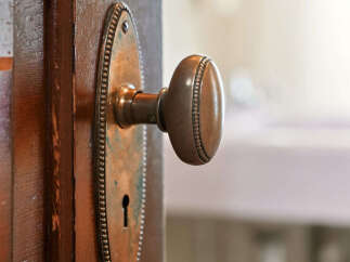 A close-up shot showcases a vintage door with a classic brass doorknob, adding a touch of elegance to any home.