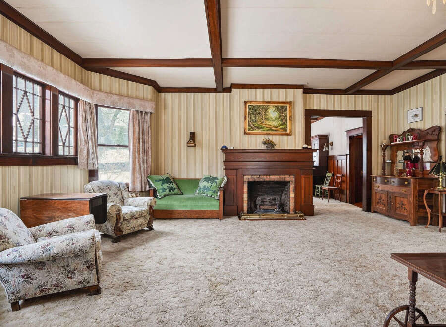 Step into this charming living room, featuring a cozy fireplace and elegant wooden accents.