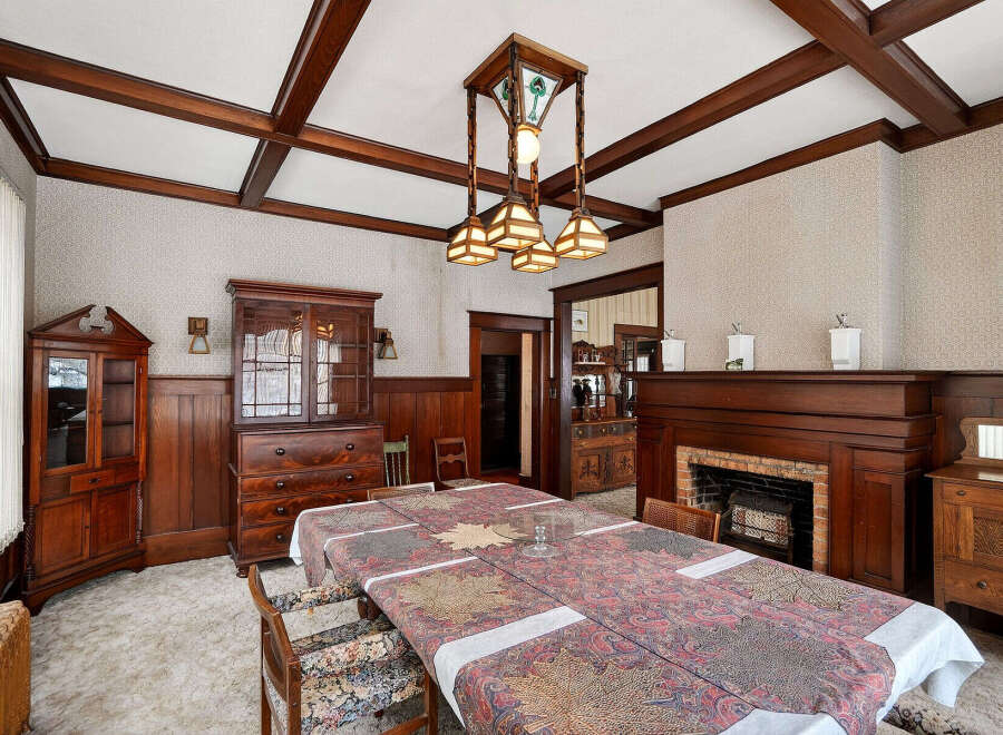 Step into a beautifully preserved dining room, showcasing exquisite craftsmanship and timeless elegance.