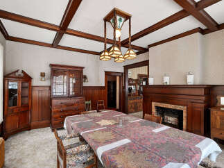 Step into a beautifully preserved dining room, showcasing exquisite craftsmanship and timeless elegance.