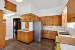 Step into this charming kitchen, featuring classic wooden cabinetry and a functional layout.