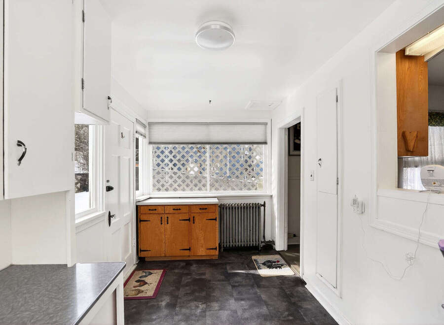 Step into this charming kitchen, featuring classic cabinetry and a bright, airy atmosphere.