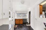 Step into this charming kitchen, featuring classic cabinetry and a bright, airy atmosphere.