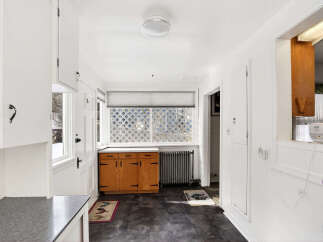 Step into this charming kitchen, featuring classic cabinetry and a bright, airy atmosphere.