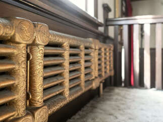 Discover the charm of this historic property, featuring original details like this ornate radiator.