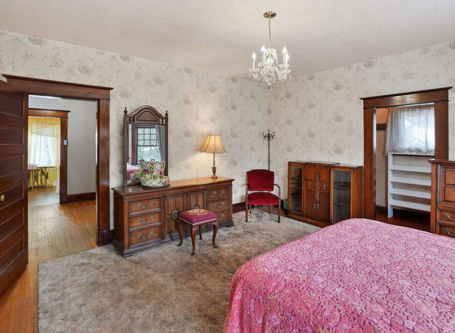 Step into this charming bedroom, featuring a classic design with a touch of vintage elegance.
