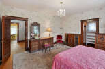 Step into this charming bedroom, featuring a classic design with a touch of vintage elegance.