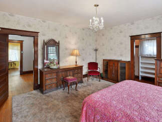 Step into this charming bedroom, featuring a classic design with a touch of vintage elegance.