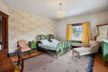 Step back in time with this charming bedroom featuring vintage decor and a cozy atmosphere.