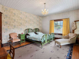 Step back in time with this charming bedroom featuring vintage decor and a cozy atmosphere.