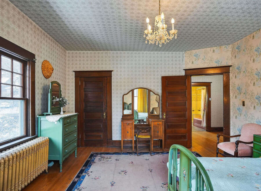 Step back in time with this charming bedroom, featuring original hardwood floors and vintage details.