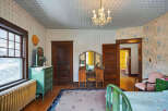 Step back in time with this charming bedroom, featuring original hardwood floors and vintage details.