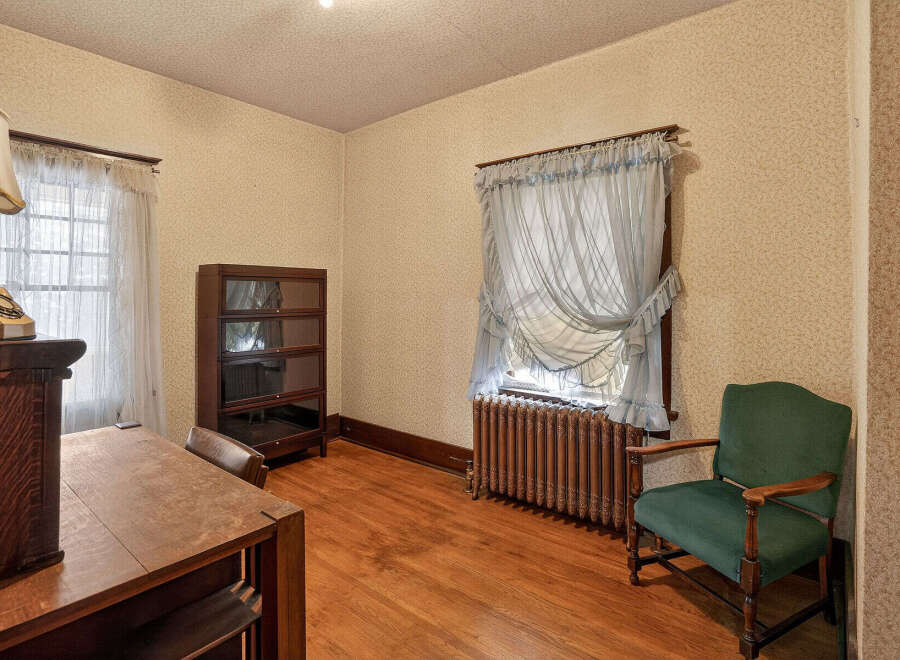 Step back in time with this charming room featuring original hardwood floors and classic details.