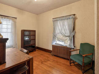 Step back in time with this charming room featuring original hardwood floors and classic details.