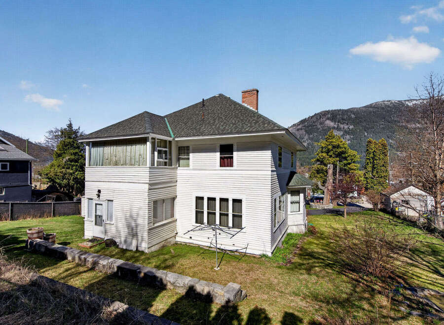 This charming white house offers a blend of classic design and modern comfort.