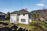 This charming white house offers a blend of classic design and modern comfort.