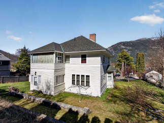 This charming white house offers a blend of classic design and modern comfort.