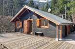 Escape to the mountains in this charming cabin! This cozy retreat features a rustic wooden deck, perfect for enjoying the surrounding natural beauty.
