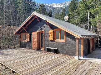 Escape to the mountains in this charming cabin! This cozy retreat features a rustic wooden deck, perfect for enjoying the surrounding natural beauty.