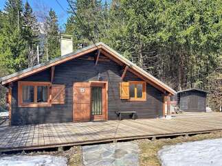 Discover the charm of this cozy cabin nestled in a serene, wooded setting.