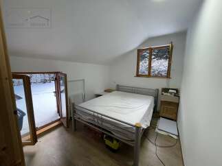 This cozy bedroom offers a serene retreat with its bright, airy atmosphere and a comfortable bed.