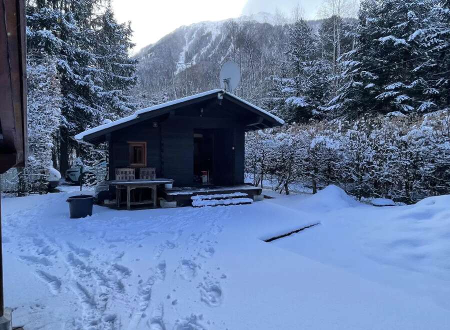 Nestled in a serene winter wonderland, this charming cabin offers a cozy retreat.