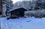 Nestled in a serene winter wonderland, this charming cabin offers a cozy retreat.