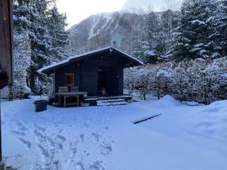 Nestled in a serene winter wonderland, this charming cabin offers a cozy retreat.