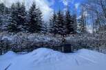 This stunning property boasts a picturesque winter landscape, perfect for those seeking tranquility and natural beauty.