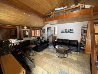 Discover this charming property featuring a cozy living space with a loft area, perfect for relaxation or entertaining.
