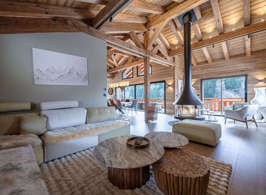 Experience luxury living in this stunning chalet, featuring a cozy fireplace and a spacious, open-plan design.