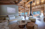 Experience luxury living in this stunning chalet, featuring a cozy fireplace and a spacious, open-plan design.