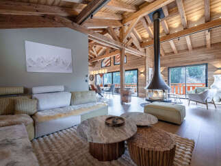 Experience luxury living in this stunning chalet, featuring a cozy fireplace and a spacious, open-plan design.