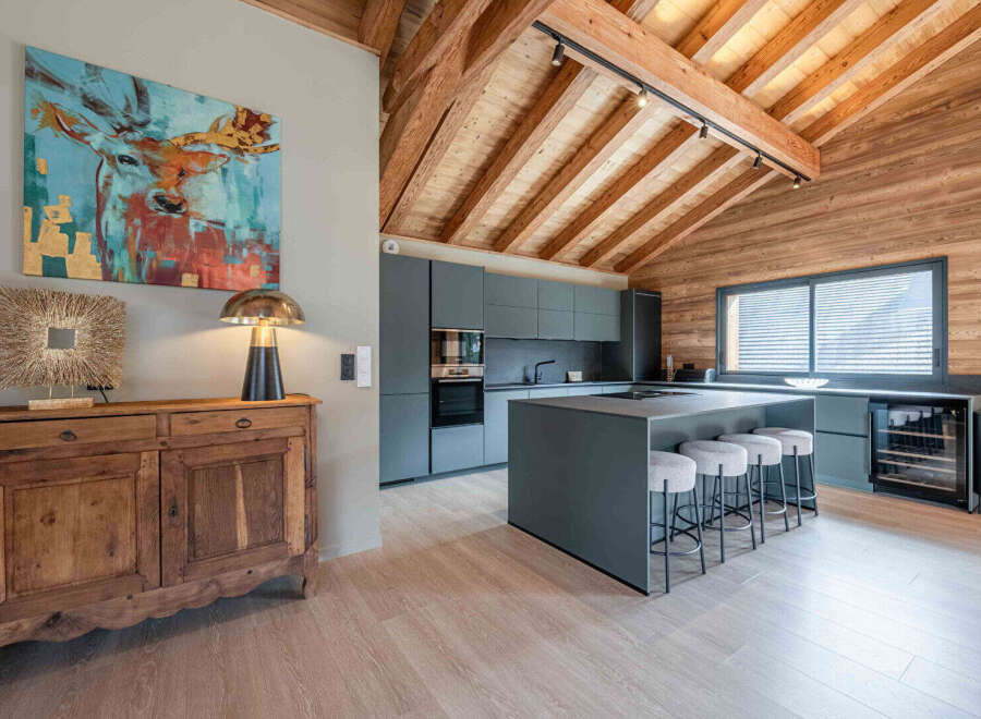 Discover the epitome of modern living in this stunning property, featuring a beautifully designed kitchen with sleek cabinetry and a spacious island.