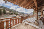 Enjoy breathtaking mountain views from this charming chalet balcony.