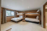 This cozy bedroom features two sets of bunk beds, perfect for accommodating a large family or group of friends.