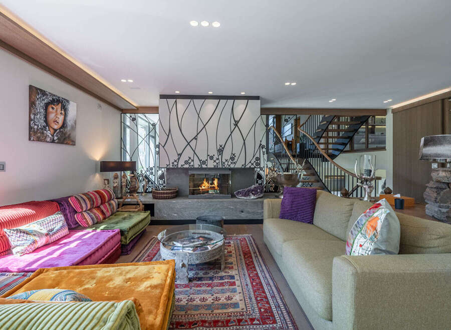 Step into luxury with this stunning living room, featuring a cozy fireplace and stylish decor.