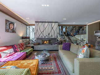 Step into luxury with this stunning living room, featuring a cozy fireplace and stylish decor.