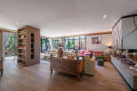 Step into luxury with this stunning living room, featuring exquisite wooden floors and a cozy fireplace.