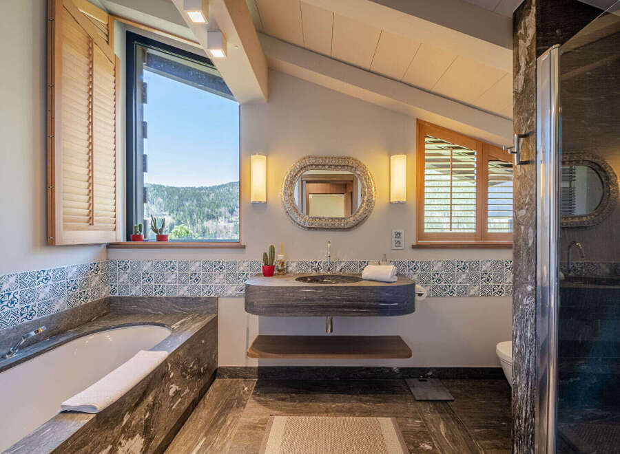 Step into luxury with this stunning bathroom, featuring a sleek, modern design.