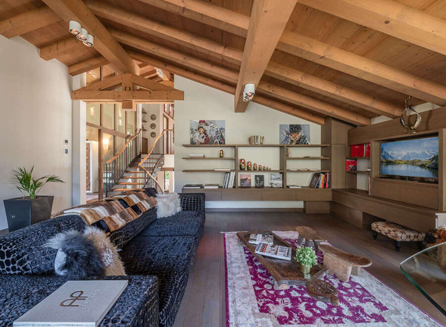 Experience luxury living in this stunning property featuring a spacious living room with a vaulted wooden ceiling.