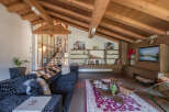 Experience luxury living in this stunning property featuring a spacious living room with a vaulted wooden ceiling.