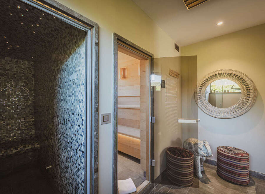 Step into luxury with this spa-like retreat! This stunning space features a sauna, a steam room, and a relaxation area, perfect for unwinding after a long day.