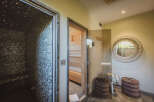 Step into luxury with this spa-like retreat! This stunning space features a sauna, a steam room, and a relaxation area, perfect for unwinding after a long day.