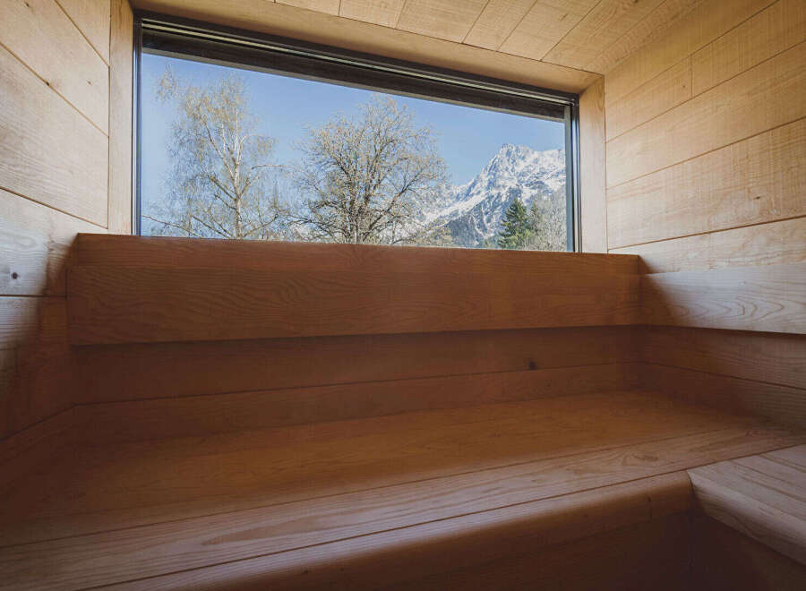 Experience tranquility in this stunning sauna with breathtaking mountain views.